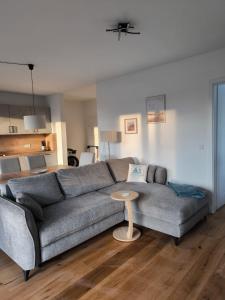 a living room with a couch and a table at SeeZeitApartments Whg 4 in Lembruch
