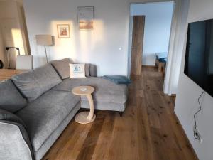 a living room with a couch and a table at SeeZeitApartments Whg 4 in Lembruch
