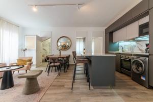 a kitchen and living room with a table and chairs at Carregado Second Floor in Carregado