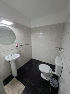 a bathroom with a white toilet and a sink at Guenechen in Colorado River +13 photos