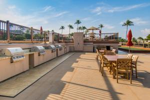 a patio with a table and chairs and a grill at Kaanapali Maui at the Eldorado by OUTRIGGER in Lahaina