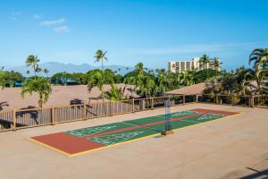 a tennis court in front of a beach with palm trees at Kaanapali Maui at the Eldorado by OUTRIGGER in Lahaina