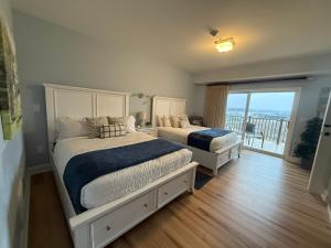 two beds in a bedroom with a balcony at Fairway To Heaven At Four Season 2bed2bath Condo in Lake Ozark +58 photos