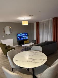 a living room with a couch and a table and chairs at Chalk in Moffat