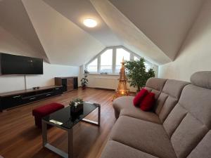 a living room with a couch and a television at Apartment with garage and garden 