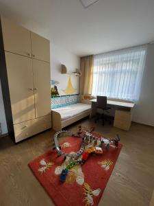 a small room with a bed and a red rug at Baťovský dům ZLÍN in Zlín