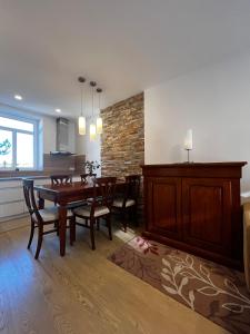 a dining room with a wooden table and chairs at Baťovský dům ZLÍN in Zlín +13 photos