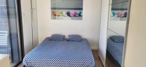 a bedroom with a bed and two mirrors at Architect-designed villa, overlooking Agay Bay in Saint-Raphaël +12 photos