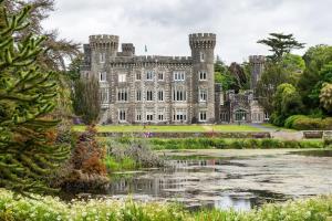an old castle with a pond in front of it at The Forge Cottage 1 in Wexford