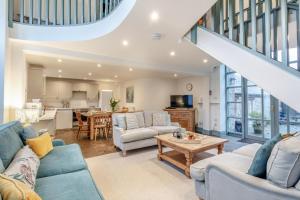 a living room with blue couches and a table at 4 Bed in Shebbear oc-w33730 in Black Torrington