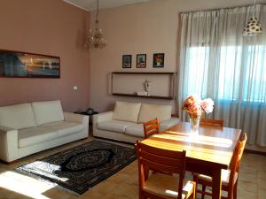 a living room with a table and a couch at Seven B&b in Casalmorano