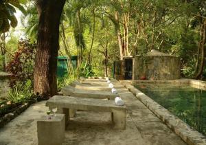 a row of concrete benches next to a pool at Hotel Hacienda Concá in Conca