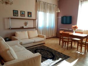 a living room with a couch and a dining room at Seven B&b in Casalmorano