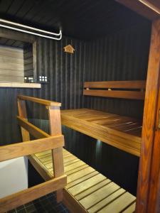 a sauna with wooden shelves and a wooden bench at Perniön majoitus alakerta in Perniö