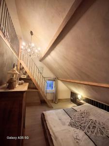 a attic room with a bed and a staircase at Duo La belle échappée & Romance in Poperinge +57 photos
