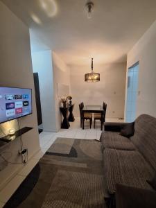 a living room with a couch and a table at Apartamento Condomínio Turu a 6km da Praia in Maioba