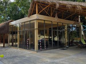 a glass building with a car inside of it at Hotel El Paraíso Calakmul in Xpujil