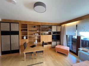 a living room with a wooden table and a desk at Cozy Apartment in Inzell in Inzell