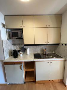 a kitchen with a sink and a microwave at Cozy Apartment in Inzell in Inzell
