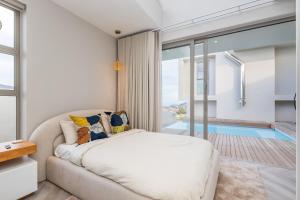 a bedroom with a bed and a swimming pool at Pinnacle Villa in Plettenberg Bay +124 photos
