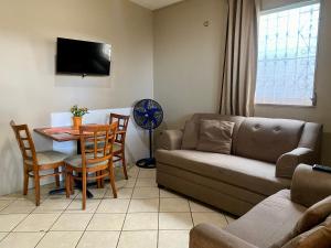a living room with a couch and a table at La Casita in San Pedro Sula