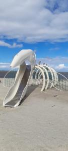 a row of metal sculptures on a beach at Ferienhaus Seestern in Dornum +6 photos