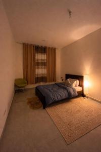 a bedroom with a bed and a window at Vi Home Stay Corniche in Abu Dhabi