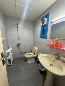 a bathroom with a toilet and a sink at Vi Home Stay Corniche in Abu Dhabi