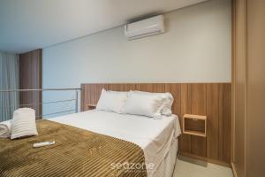 a bedroom with a bed with a air conditioner on it at Full Loft 290 m from the Beach CPH0202 in Florianópolis