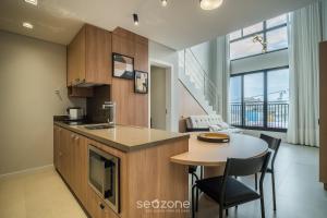 a kitchen with a table and a small table with chairs at Full Loft 290 m from the Beach CPH0202 in Florianópolis