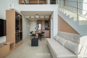 a living room with a couch and a table at Full Loft 290 m from the Beach CPH0202 in Florianópolis