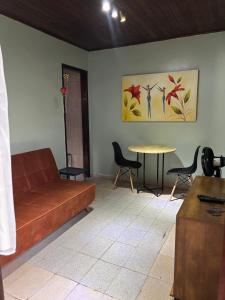 een woonkamer met een bank en een tafel bij Casa da Gigi in Arraial do Cabo