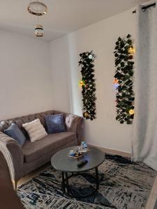 a living room with a couch and a table at EnkishoniBnB Kitengela in Nairobi +2 photos
