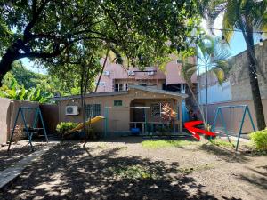 a house with a red arrow in front of it at La Casita in San Pedro Sula