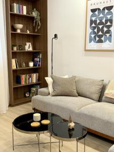 a living room with a couch and a table at Bratislava Cozy Corner Apartment in Vinohrady