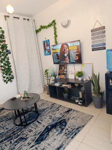 a living room with a table and a rug at EnkishoniBnB Kitengela in Nairobi