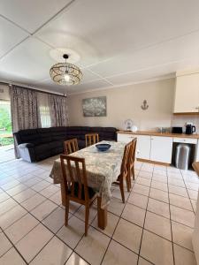 a kitchen and living room with a table and chairs at Aloha Sands Scottburgh in Scottburgh