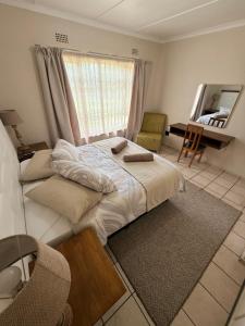 a bedroom with a large bed and a mirror at Aloha Sands Scottburgh in Scottburgh +19 photos
