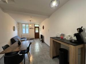 a kitchen and living room with a table and chairs at Gîte Le Central - Port & Plage in Fécamp
