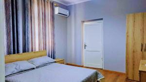 a bedroom with a bed and a window and a door at Spacious Waterfront 3BR - 2Bath & 3 Panoramic Balconies - Pogradec, Lake Ohrid in Pogradec