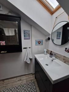 a bathroom with a sink and a mirror at Domek pod Lasem in Bełchów
