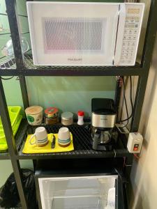 a microwave sitting on a shelf in a refrigerator at Mini Suite Apartamento in San Pedro Sula