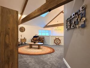 a living room with a table and a couch at The Barn in Skipton