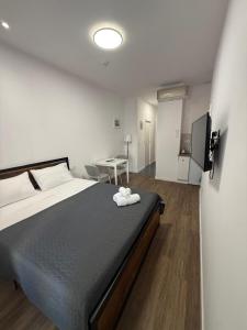 a bedroom with a large bed and a table at HS Beach in Torrevieja
