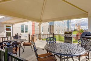 a patio with tables and chairs and a grill at Park Inn by Radisson, Calgary Airport North, AB in Calgary