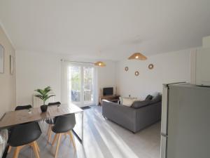 a kitchen and living room with a couch and a table at gitelepetitvallon in Allemagne-en-Provence
