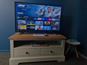 a flat screen tv sitting on top of a dresser at DuxHouse BnB in Taihape