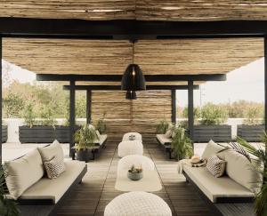 an outdoor patio with couches and chairs and a table at Hotel Circulo in Charleston