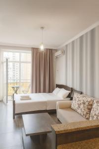 a living room with two beds and a couch at Ia's Home in Tbilisi City
