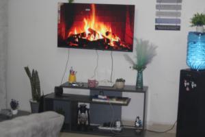 a living room with a fireplace on a tv at EnkishoniBnB Kitengela in Nairobi